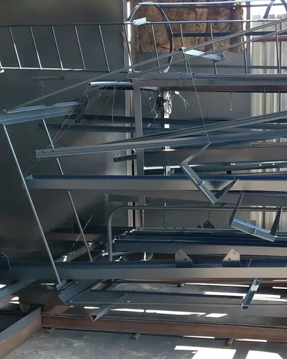 Fabricated and coated steel components prepared for industrial plant installation